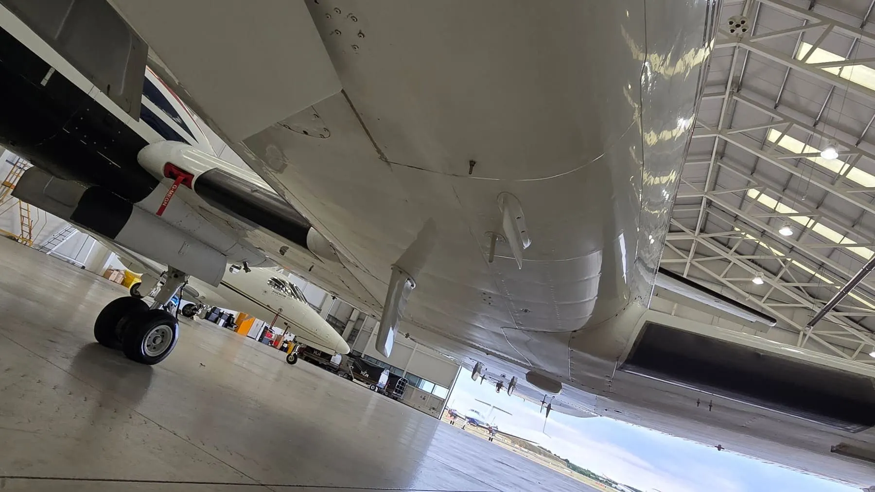 Clean aircraft belly and underside in a hangar after degreasing