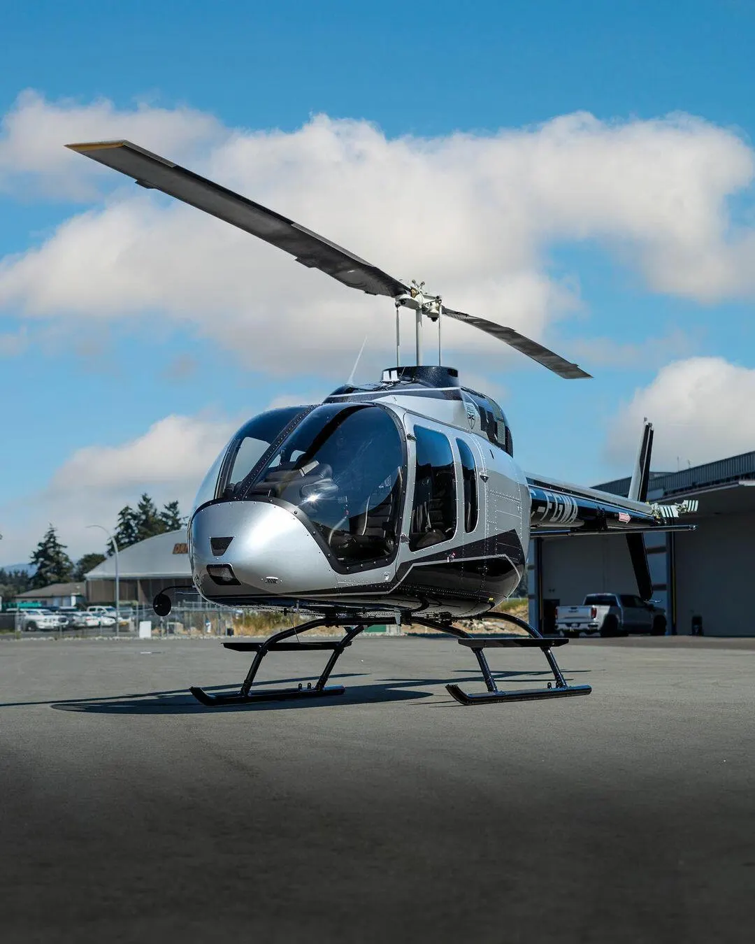 Clean Bell helicopter on the ramp under a clear blue sky