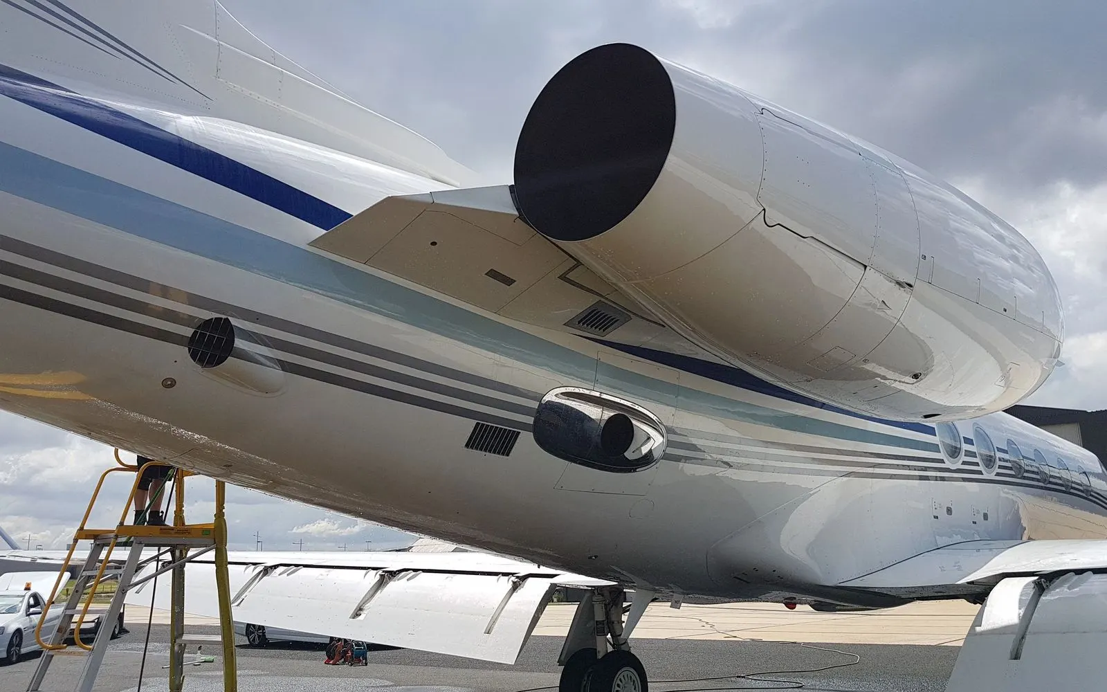 Underside of a midsize jet wing and engine nacelle after washing
