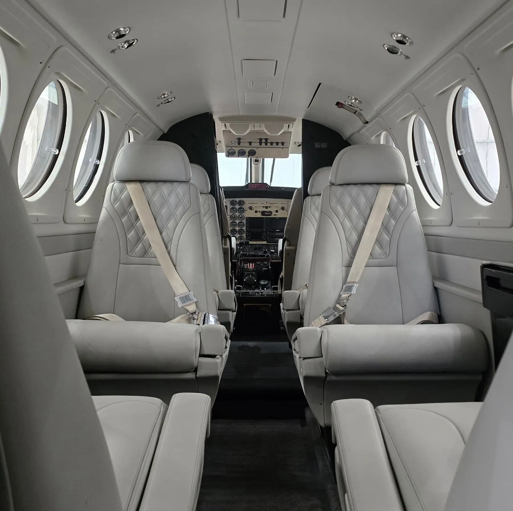 King Air cabin with white quilted leather seating after interior detailing