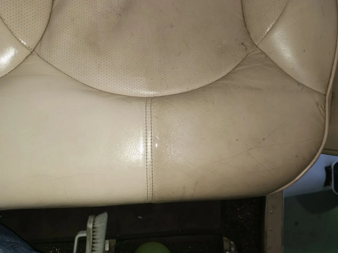 Close detail of conditioned cream aircraft leather with clean stitching